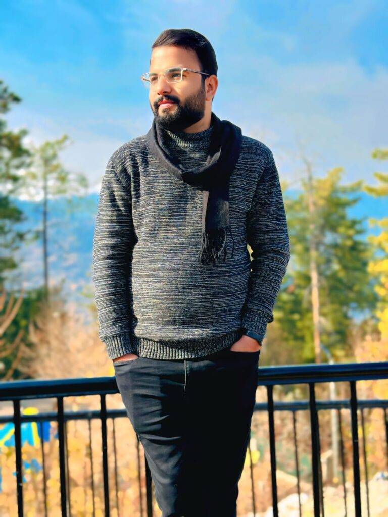 Man in a stylish winter outfit enjoying scenic mountain views